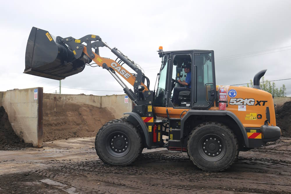 excavator driving through a work site